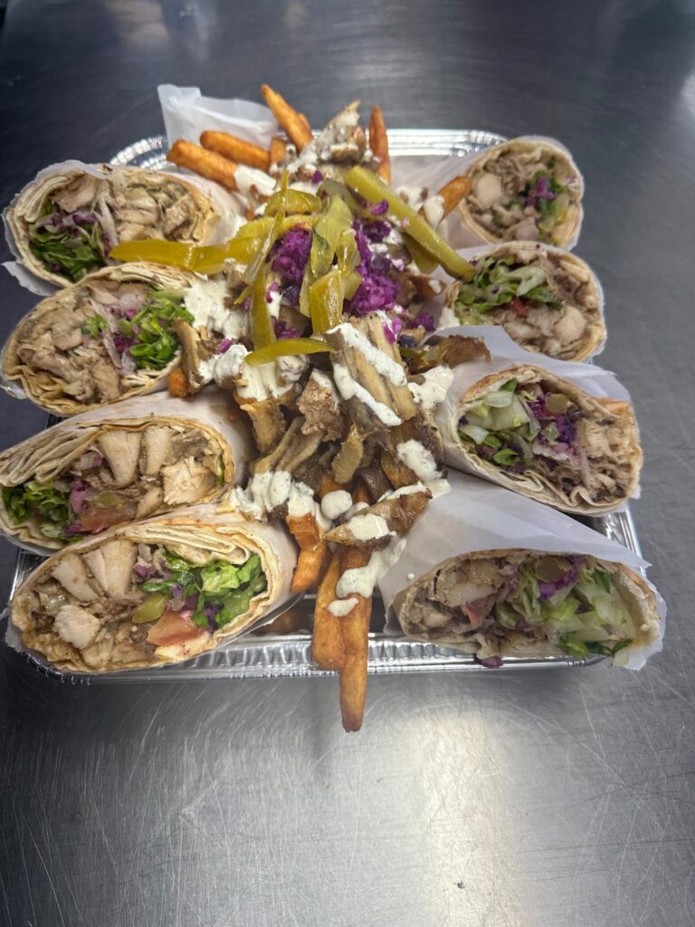 Family tray of chicken shawarma wraps with fries